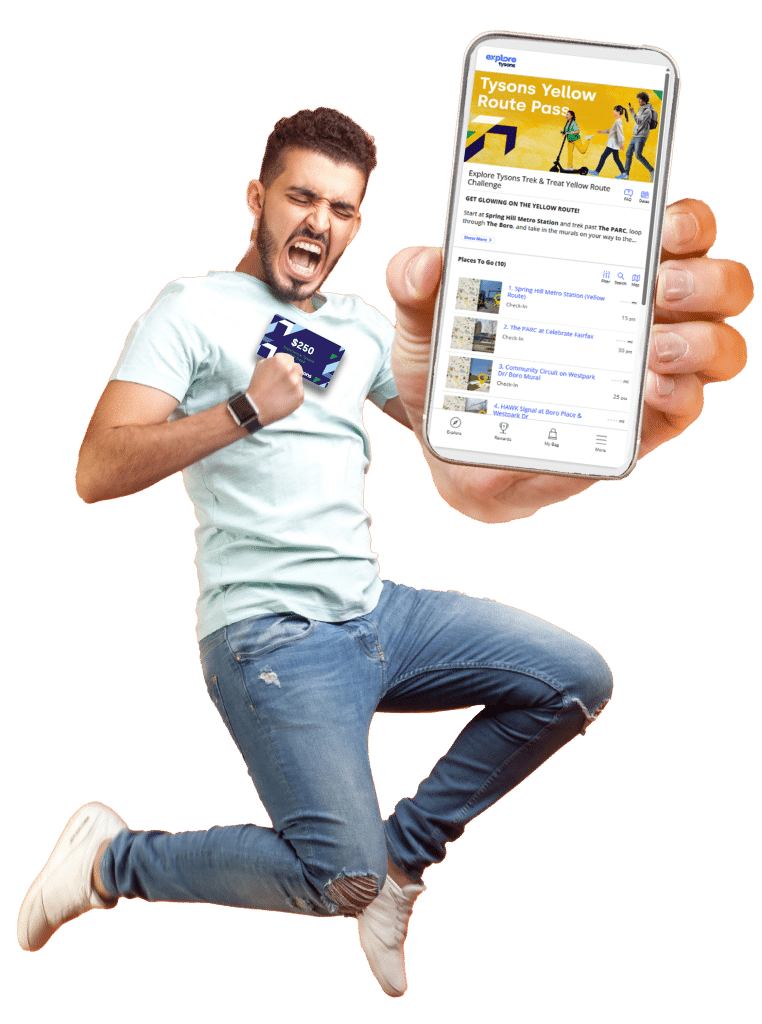 Man jumping and cheering holding phone out showing Tysons Yellow Route Pass and holding a $250 gift card
